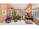 Spacious living room with a tan sofa, white shelving, dining table and large windows with plantation shutters at 3544 N Paseo Del Sol --, Mesa, AZ 85207