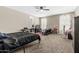 Large bedroom with carpet flooring, bright light from windows, and decorated with several objects at 37645 W Santa Clara Ave, Maricopa, AZ 85138