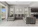 Elegant living room features neutral colors, a plush sectional sofa, and views of the outdoor at 37645 W Santa Clara Ave, Maricopa, AZ 85138
