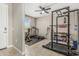 Spacious workout room with tile floors, ceiling fan, and natural light, ideal for fitness enthusiasts at 37645 W Santa Clara Ave, Maricopa, AZ 85138