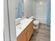 Bathroom featuring new flooring, a tub with shower, and a modern vanity at 3810 N Maryvale Pkwy # 1070, Phoenix, AZ 85031