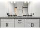Double sink bathroom vanity with grey countertop and modern black hardware at 42424 N Gavilan Peak Pkwy # 24206, Anthem, AZ 85086