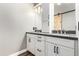 Bathroom featuring a double sink vanity with grey countertop and sliding barn door at 42424 N Gavilan Peak Pkwy # 24206, Anthem, AZ 85086