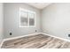 Neutral bedroom features wood-look floors, a window with blinds, and fresh paint at 42424 N Gavilan Peak Pkwy # 24206, Anthem, AZ 85086