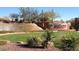 Landscaped community entrance with lush green grass, desert plants, and a decorative waterfall feature at 42424 N Gavilan Peak Pkwy # 24206, Anthem, AZ 85086