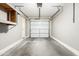 Garage featuring shelving, concrete floors, white painted walls, and garage door at 42424 N Gavilan Peak Pkwy # 24206, Anthem, AZ 85086