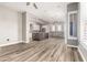 Open living room and kitchen area features wood-look tile floors and a large kitchen island with gray granite countertop at 42424 N Gavilan Peak Pkwy # 24206, Anthem, AZ 85086