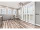 Bright living room boasts wood-look tile floors, neutral walls, shuttered windows and sliding doors to a balcony at 42424 N Gavilan Peak Pkwy # 24206, Anthem, AZ 85086
