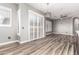 Large living room features wood-look tile floors, neutral walls, ceiling fan and many shuttered windows and sliding doors at 42424 N Gavilan Peak Pkwy # 24206, Anthem, AZ 85086