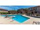 Community pool with lounge chairs, pergola, and manicured landscaping at 42424 N Gavilan Peak Pkwy # 24206, Anthem, AZ 85086