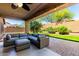 Covered patio with comfortable seating overlooking the lawn and landscaping at 43303 N 44Th Ave, New River, AZ 85087