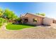 View of backyard featuring artificial grass, gravel, covered patio, and detached shed at 43303 N 44Th Ave, New River, AZ 85087