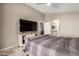 Comfortable bedroom with a large window and TV. Door leads to the bathroom and dining area at 43303 N 44Th Ave, New River, AZ 85087