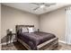 Bedroom with hardwood floors, ceiling fan and wood accent wall at 43303 N 44Th Ave, New River, AZ 85087