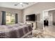 Relaxing bedroom featuring a large window, TV and cozy neutral color palette at 43303 N 44Th Ave, New River, AZ 85087