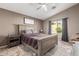 Comfortable bedroom with a large window, ceiling fan, and neutral decor at 43303 N 44Th Ave, New River, AZ 85087