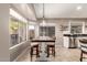 Sunlit dining area with large windows and breakfast bar, perfect for casual meals at 43303 N 44Th Ave, New River, AZ 85087