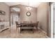 Stylish dining room with seating for six, a decorative clock, and ample natural light at 43303 N 44Th Ave, New River, AZ 85087