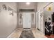 Bright foyer featuring tile flooring, a white front door, and decorative wall accents at 43303 N 44Th Ave, New River, AZ 85087