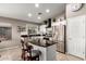 Modern kitchen with stainless steel refrigerator, white cabinets and granite countertops at 43303 N 44Th Ave, New River, AZ 85087