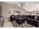 Spacious living room featuring a large, plush sectional sofa, ceiling fan, and tile flooring at 43303 N 44Th Ave, New River, AZ 85087