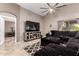 Comfortable living room featuring a large sectional sofa, modern TV, and access to the bedroom at 43303 N 44Th Ave, New River, AZ 85087