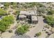 Expansive aerial view of an impressive desert-style home featuring mature trees and landscaping at 4772 E Agave Ln, Cave Creek, AZ 85331