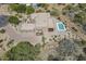 Stunning aerial view of a modern home featuring a pool, desert landscaping, and mountain views at 4772 E Agave Ln, Cave Creek, AZ 85331