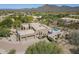 A high angle view of a single-story desert home with pool, desert landscaping and mountain views at 4772 E Agave Ln, Cave Creek, AZ 85331