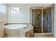 Bathroom features a soaking tub, a separate glass shower, and a window to add natural light to the space at 4772 E Agave Ln, Cave Creek, AZ 85331
