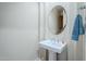 Elegant pedestal sink and oval mirror create a sophisticated look in this well-lit bathroom at 4772 E Agave Ln, Cave Creek, AZ 85331