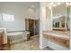 Bright bathroom offers a soaking tub, walk-in shower, and vanity area for a luxurious experience at 4772 E Agave Ln, Cave Creek, AZ 85331