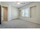 Bright bedroom featuring neutral carpet, ceiling fan, closet, and a large window with views at 4772 E Agave Ln, Cave Creek, AZ 85331