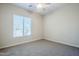 Bright bedroom features a ceiling fan, large window, and neutral carpeting at 4772 E Agave Ln, Cave Creek, AZ 85331