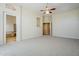 Large main bedroom provides neutral carpet, a ceiling fan, and bathroom access for convenient living at 4772 E Agave Ln, Cave Creek, AZ 85331