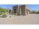 Exterior view of a desert-style home featuring native landscaping and a brick-paved driveway at 4772 E Agave Ln, Cave Creek, AZ 85331