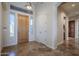 Inviting foyer featuring a wooden front door, tile flooring, and natural light at 4772 E Agave Ln, Cave Creek, AZ 85331