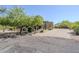 Inviting front yard with desert landscaping, mature trees, and a paved driveway, exuding curb appeal at 4772 E Agave Ln, Cave Creek, AZ 85331