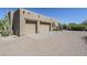 Exterior view of a desert-style home featuring a two car garage and brick-paved driveway at 4772 E Agave Ln, Cave Creek, AZ 85331