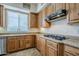 Bright kitchen features wooden cabinets, granite countertops, and a gas stovetop, offering a functional cooking space at 4772 E Agave Ln, Cave Creek, AZ 85331