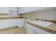 Well-equipped laundry room with ample counter space, storage cabinets, and sink at 4772 E Agave Ln, Cave Creek, AZ 85331