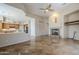 Spacious living area with an open kitchen, seamless flooring, and a fireplace, perfect for gatherings at 4772 E Agave Ln, Cave Creek, AZ 85331