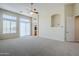 Open living room offering neutral carpet, sliding glass doors to the outside, and a ceiling fan at 4772 E Agave Ln, Cave Creek, AZ 85331