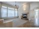 Bright living room with a fireplace, high ceilings, and large windows providing natural light at 4772 E Agave Ln, Cave Creek, AZ 85331