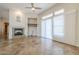 Bright living room featuring fireplace, ceiling fan and large windows with pleated blinds at 4772 E Agave Ln, Cave Creek, AZ 85331