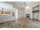 Spacious living room features a fireplace, ceiling fan and opens up to a beautifully appointed kitchen at 4772 E Agave Ln, Cave Creek, AZ 85331
