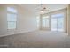 Bright living room featuring a ceiling fan, neutral carpet, and sliding glass doors for an airy atmosphere at 4772 E Agave Ln, Cave Creek, AZ 85331
