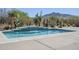 Beautiful pool with stone trim and cascading waterfall feature against desert landscaping and mountain views at 4772 E Agave Ln, Cave Creek, AZ 85331
