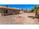 Charming backyard with a brick fire pit, covered patio, and lush palm tree at 5237 W Mountain View Rd, Glendale, AZ 85302