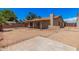 Exterior view of a backyard with mature trees and desert landscaping at 5237 W Mountain View Rd, Glendale, AZ 85302